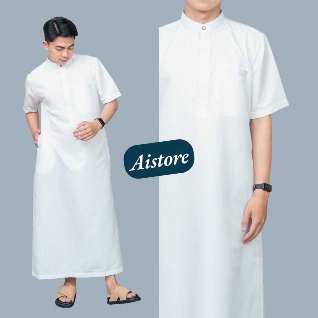 Man wearing a white short-sleeved thobe with a mandarin collar, chest pocket, and sandals.